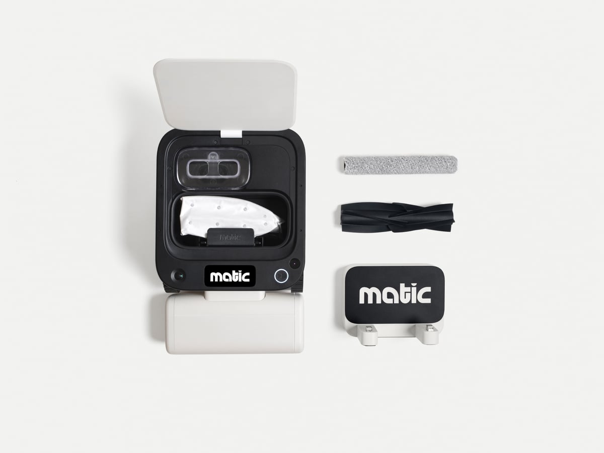 The Matic opened up alongside its mop roller, brush roll and dock plate, showing the bag and water tank that normally live in a dock